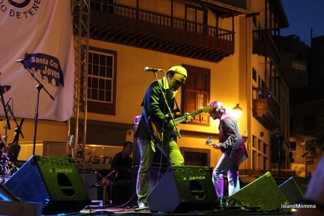 person playing guitar on stage at Sant aBlues