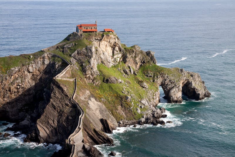 A rocky island in the middle of a body of water