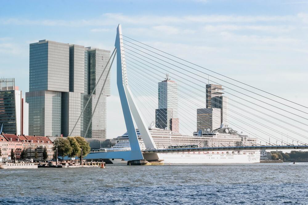cruise shipped parked behind bridge in rotterdam port