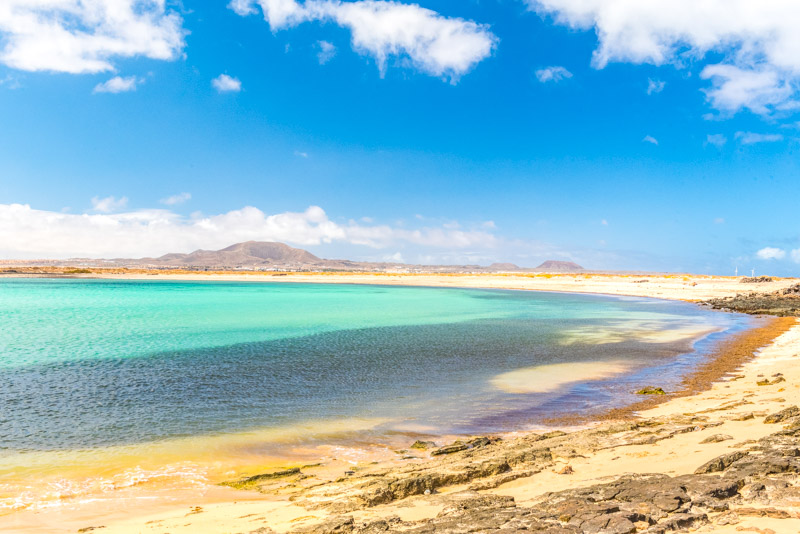 curving beach and brilliant blue water of Isla Lobos