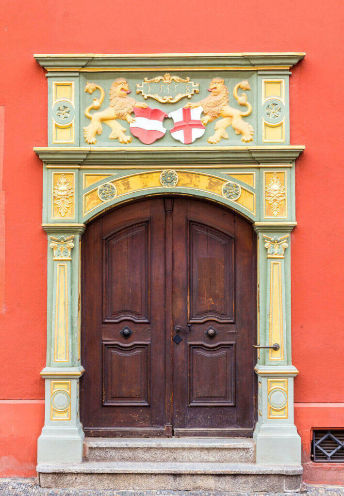 wooden door on orange building