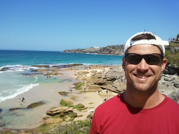 A man standing on a beach and smiling