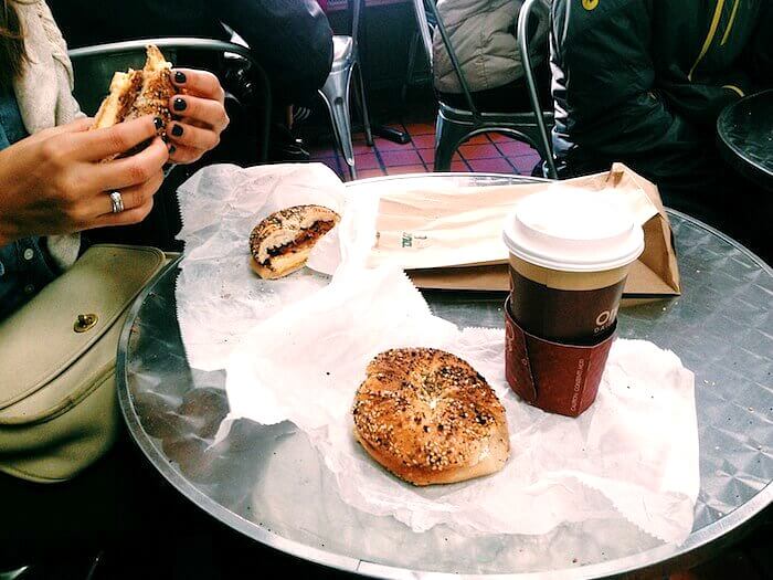 Absolute Bagels and coffee cup on table