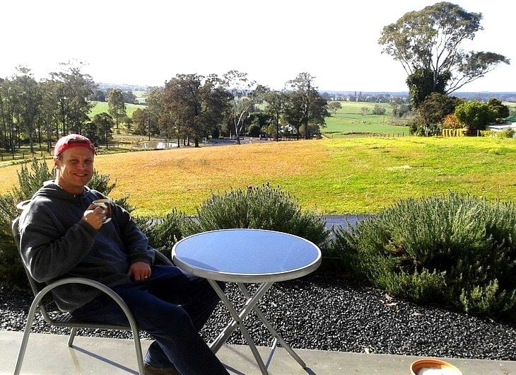 a man sitting at a table outside