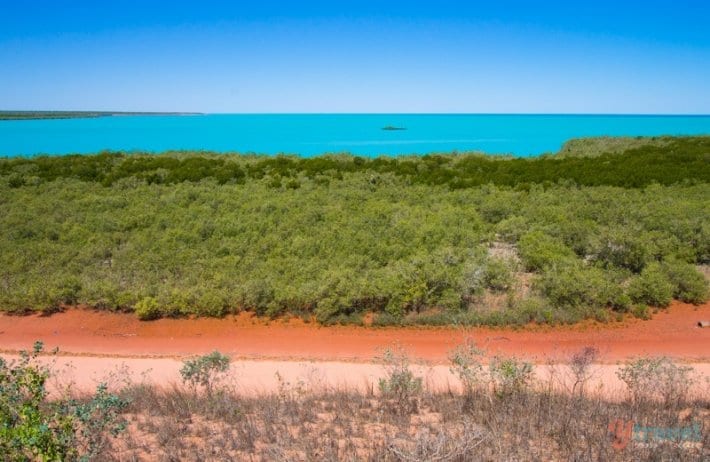 orange dirt, green bush and turquoise water of Broome as seen from Mangrove Hotel - 