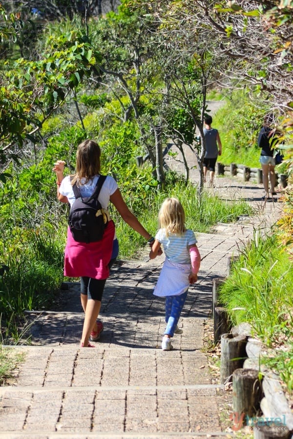 woman and girl holding hands going down steps