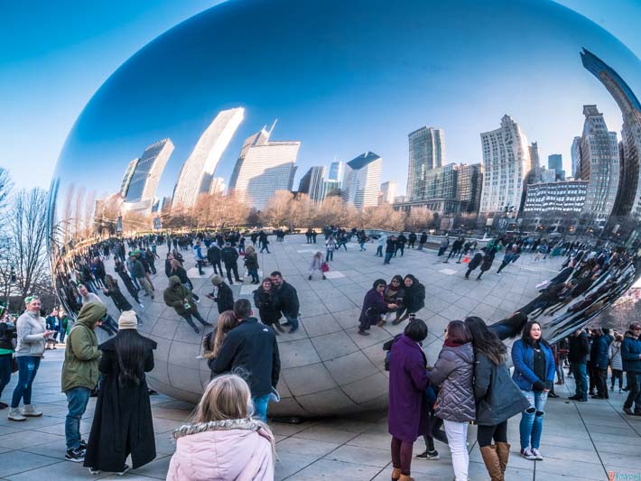 people looking into chicago skyline reflected  in the Cloud Gate Chicago Bean