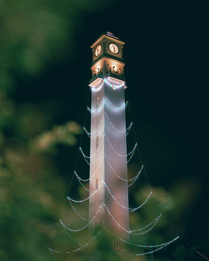 clock tower with string lights on it