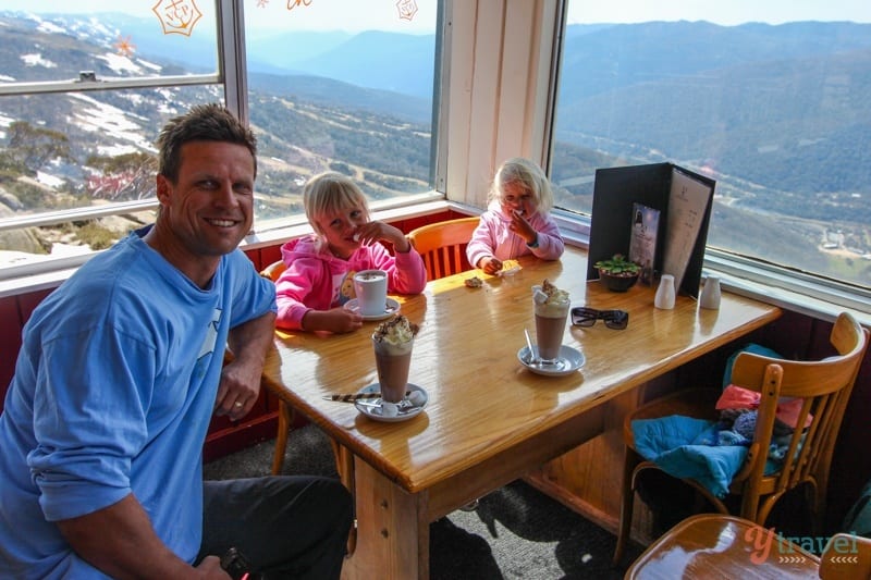 family posing  at Eagles Nest restaurant Thredbo with view 