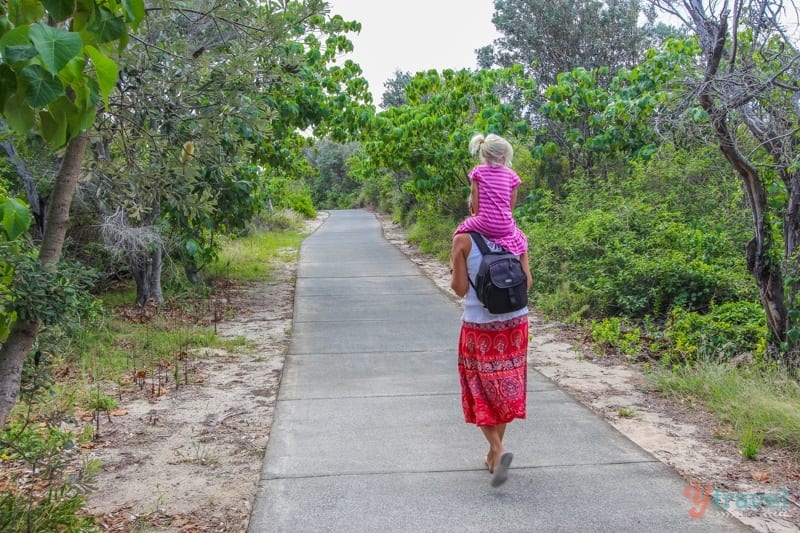 people walking on paved trail