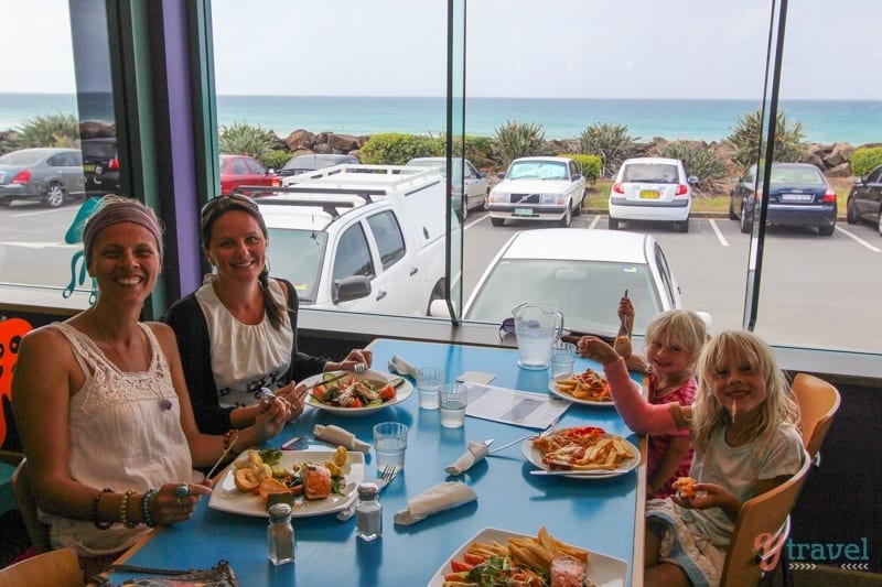 people smiling to camera eating lunch at bowling club