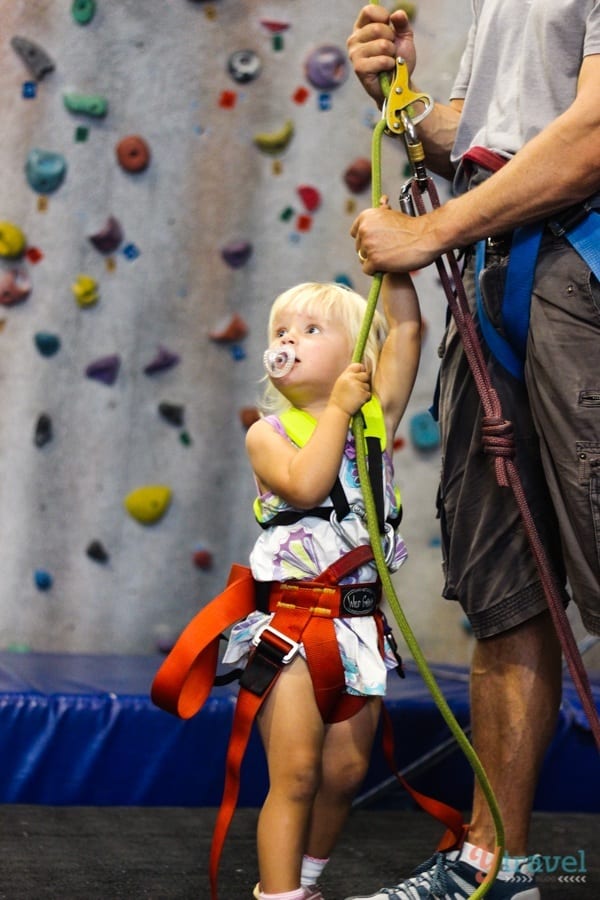 young girl trying to belay with harness on indoor rock climbing Wollongong