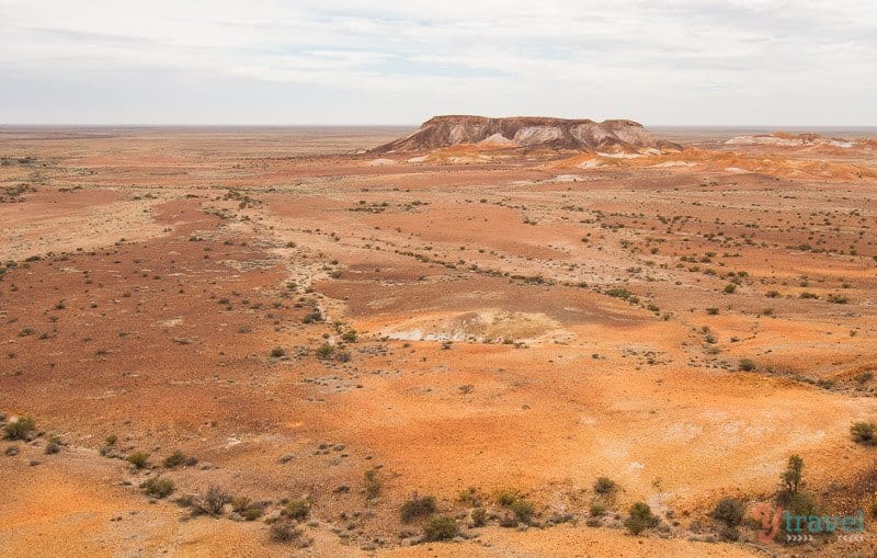 orange desert with small rock mound Coober Pedy South Australia