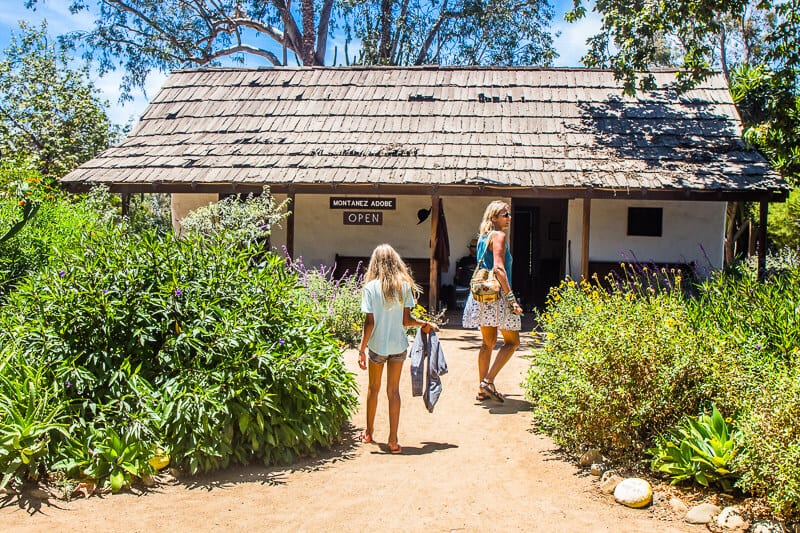 people walking up to small home in Los Rios Historic District,