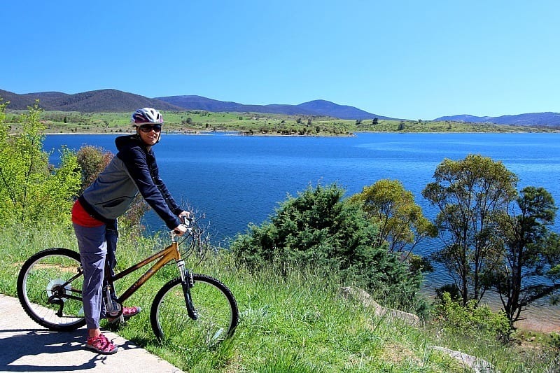 woman on bike beside Lake Jindabyne, Snowy Mountains