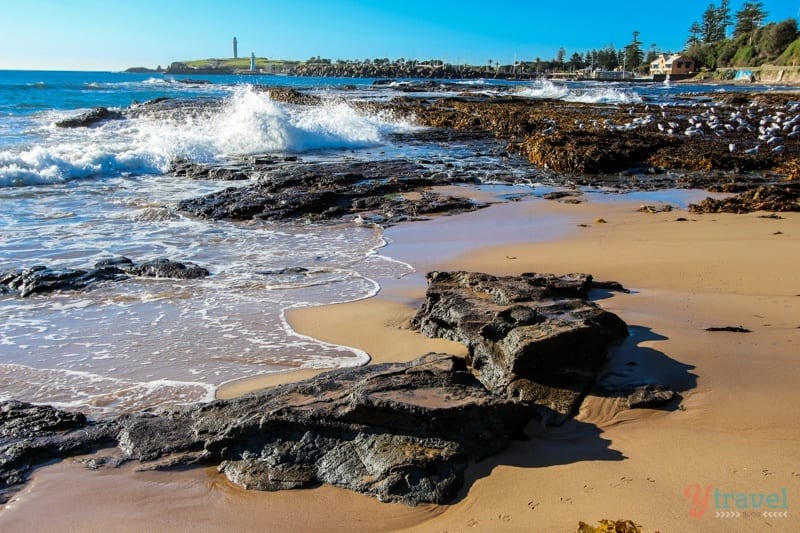 waves crashing against rocks on Wollongong Beach, Australia