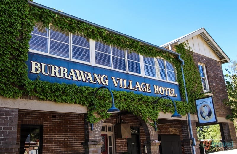 A sign in front of a brick building