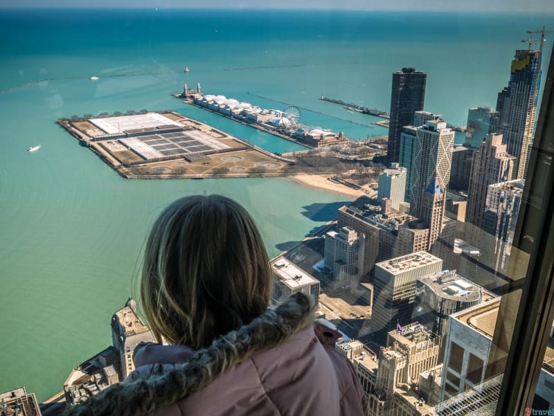 girl looking at Lake Michigan views from 360 Observatory John Hancock Chicago (1)