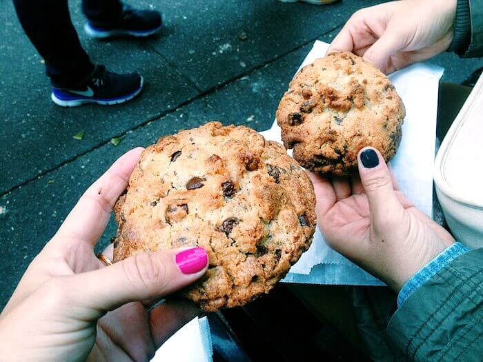 people holding Cookies at Levain Bakery 