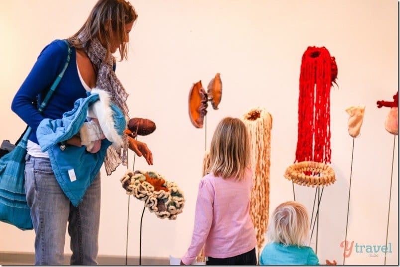 people looking at art sculpture