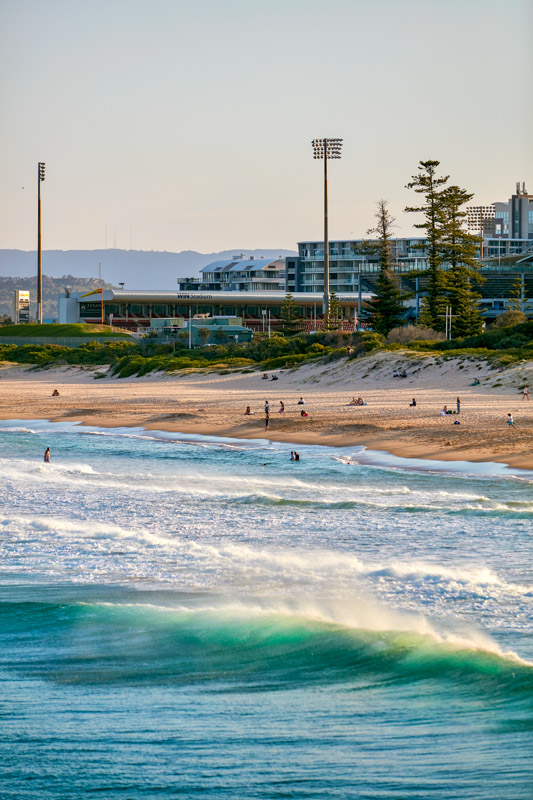 People enjoying the sand and surf at Main Beach, Wollongong.