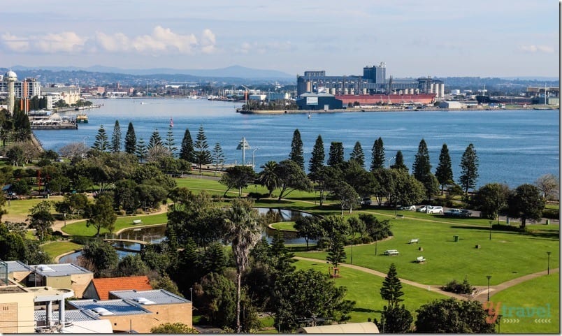 a park and buildings next to water