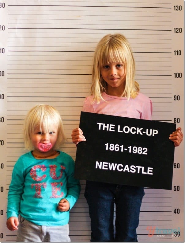 two girls holding a sign that reads The Lock Up Newcastle 