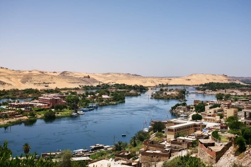 River Nile  with desert mojntiansin the background and fertile green shores