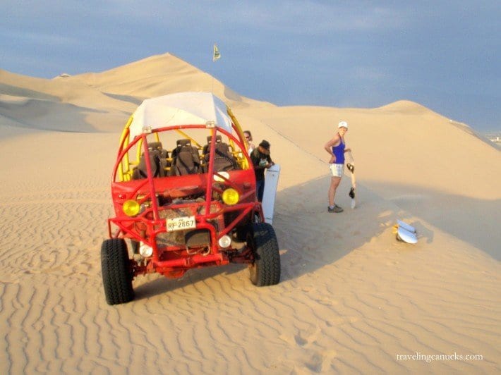 red dune buggy on dunes