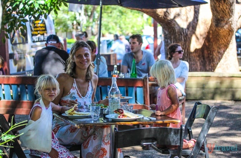 womand children eating at outside table