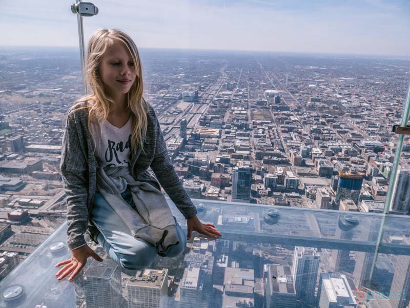 girl sitting on glass Skydeck The Ledge Willis Tower 