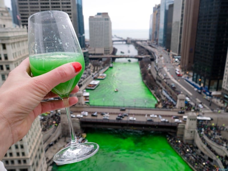 hand holding green cocktail with views of a green Chicago River (1)