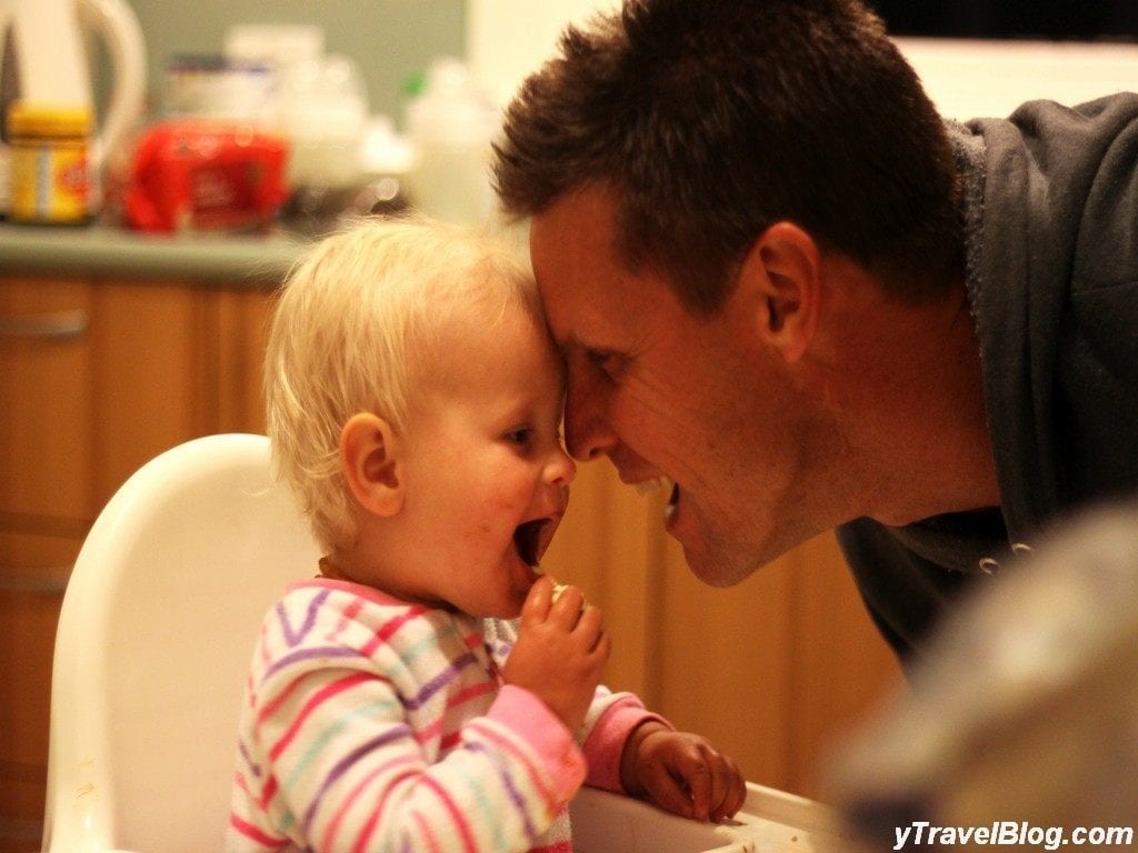 a man and a baby touching foreheads