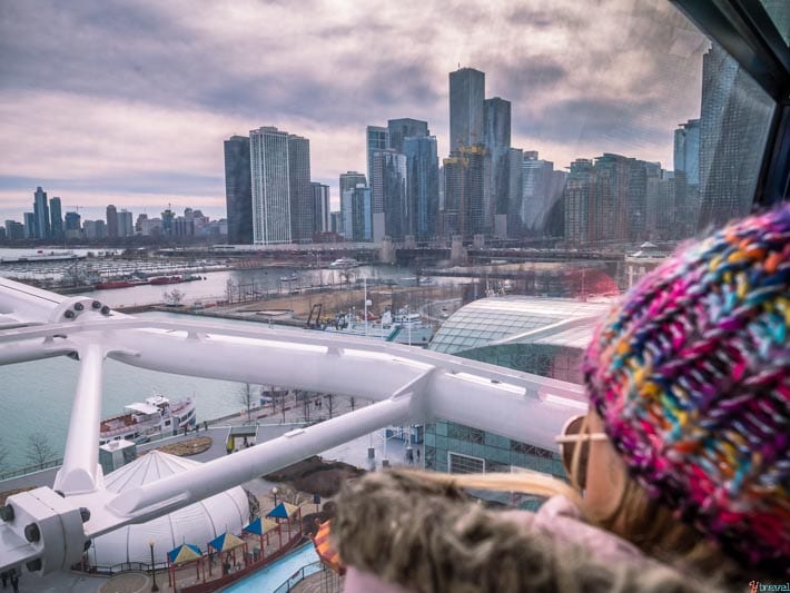 girl looking at chicago skyline view out the window of the The Centennial Wheel 