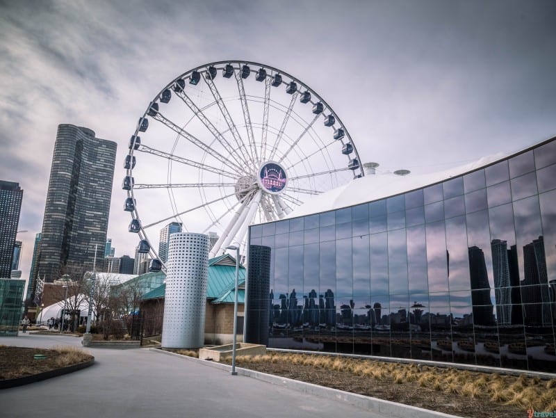 The Centennial Wheel in the middle of buildings at Navy Pier Chicago