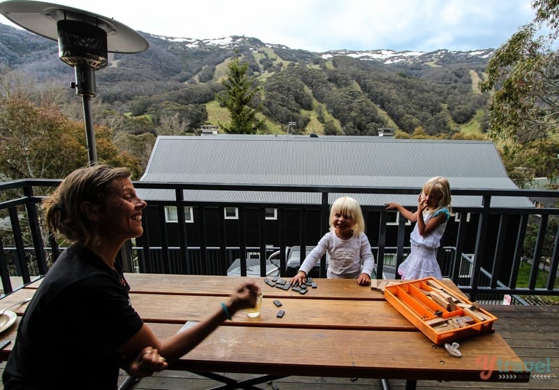 family playing games at table with views of mountains