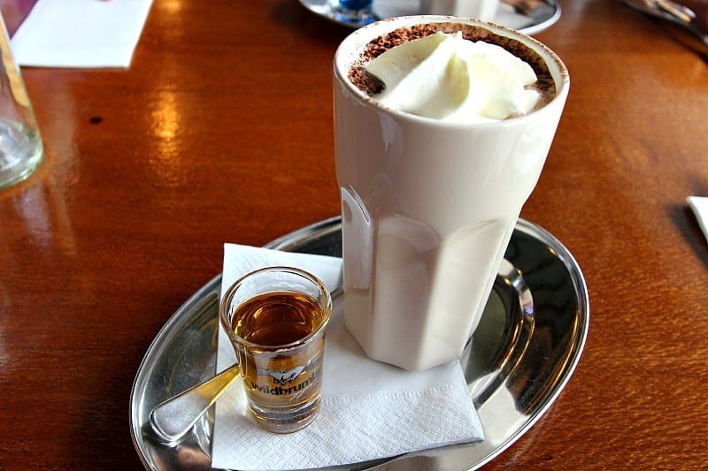 hot chocolate on tray with wild brumby schapps beside it