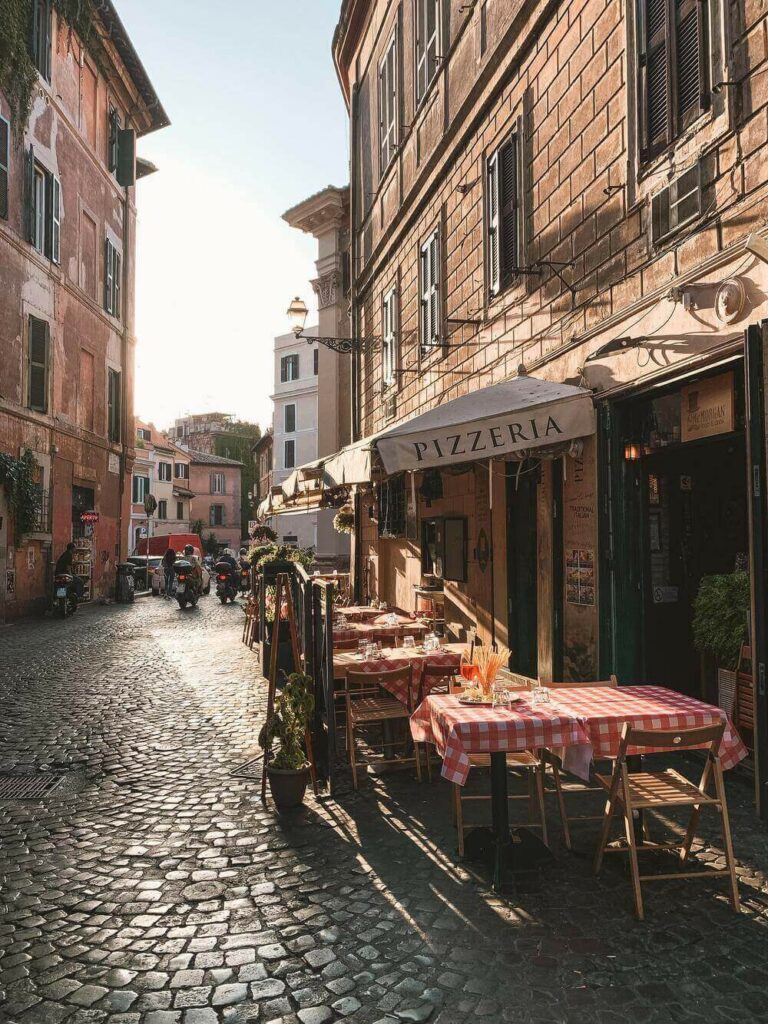 red and white checkered table cloths on cobblestone street outside pizzeria Trastevere