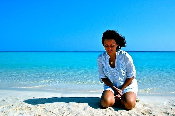 a woman sitting on a beach