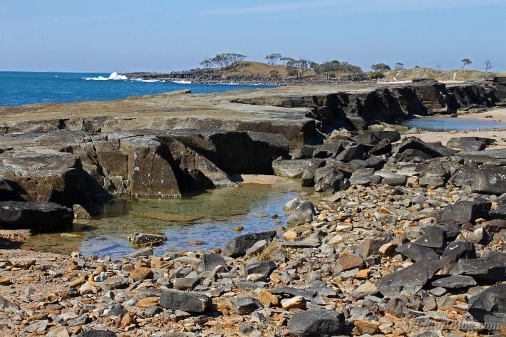 A rocky beach next to a body of water