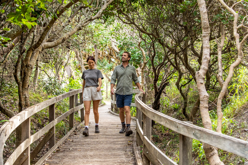 Couple enjoying a walk along the Yuraygir Coastal Walk, Angourie.