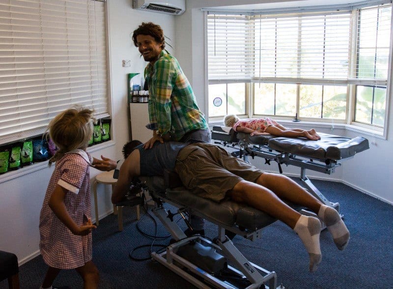 chiropractor adjusting man on table