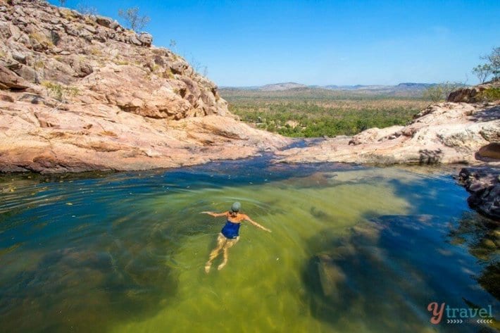 woman swimming in gunlom falls waterhole in kaakdu