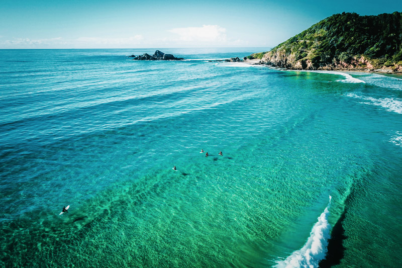 People enjoying a morning surf at Broken Head Beach, Byron Bay.