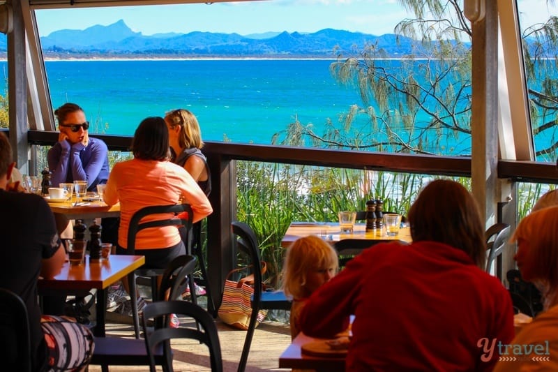 people on Byron Beach Cafe deck with ocean views