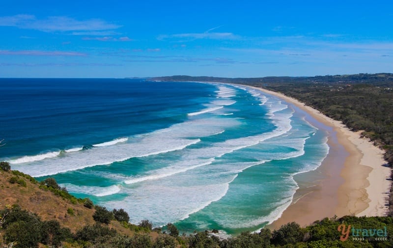 aerial view of waves rolling into Tallows Beach