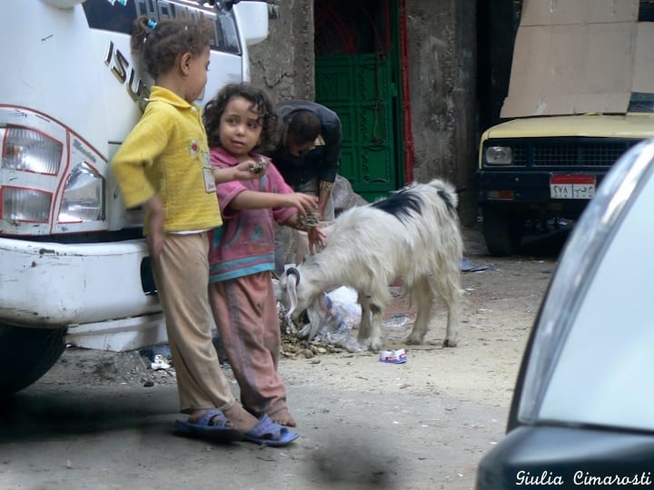 kids leaning on a car