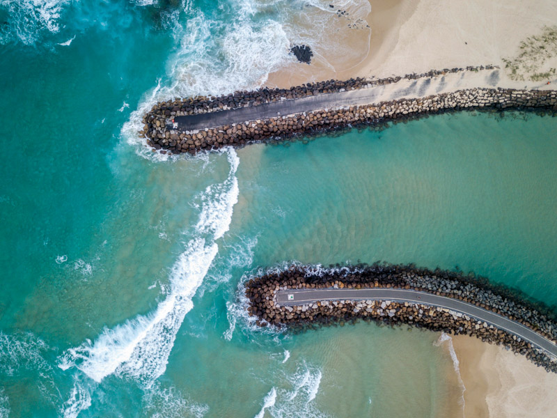 Aerial over Cudgen Creek break walls, Kingscliff in the Northern Rivers region of NSW.