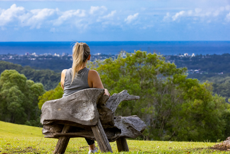 woman sitting on chair looking at views of Views down to Surfers Paradise from the gardens 