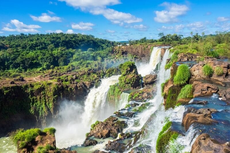 iguazu falls tumbling amongst lush greenery